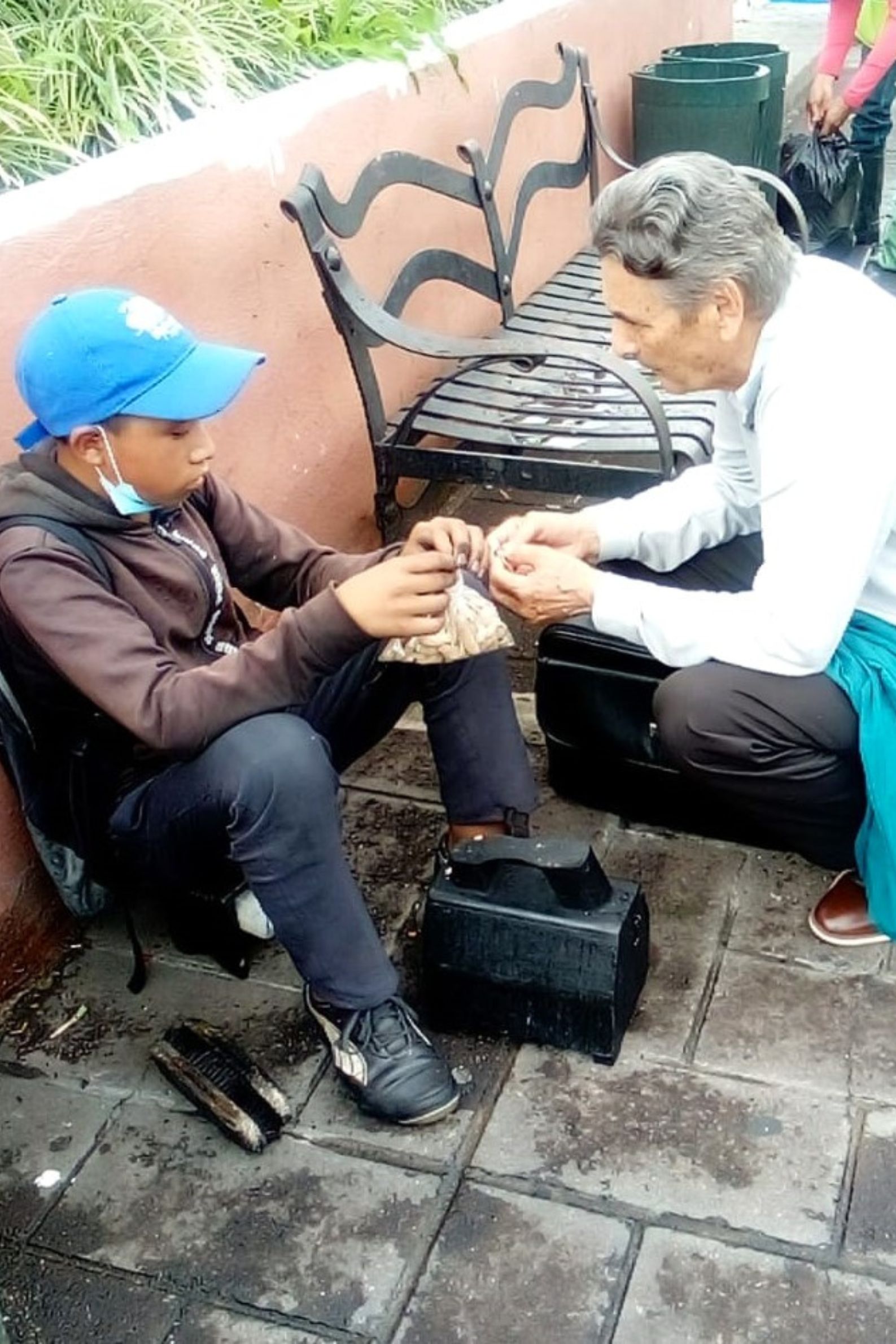 Pedro helping boy on the Guatemala streets